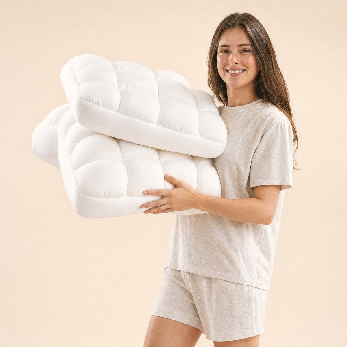 Woman holding two White Lune pillows