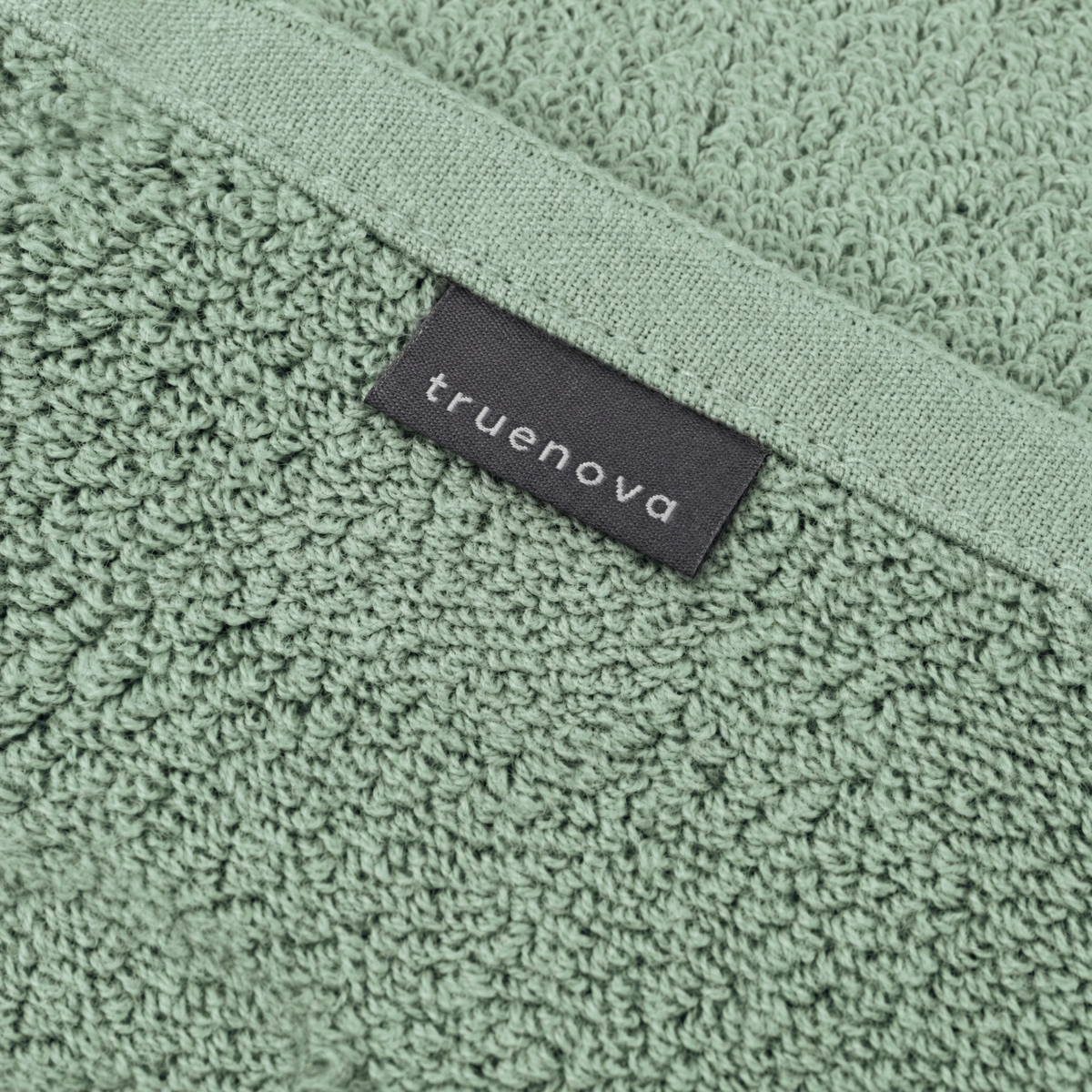 Truenova woven label on the hem of a Solace towel