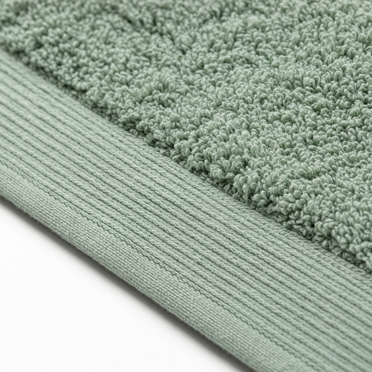 Close-up of the Solace towel hem and ribbed dobby border