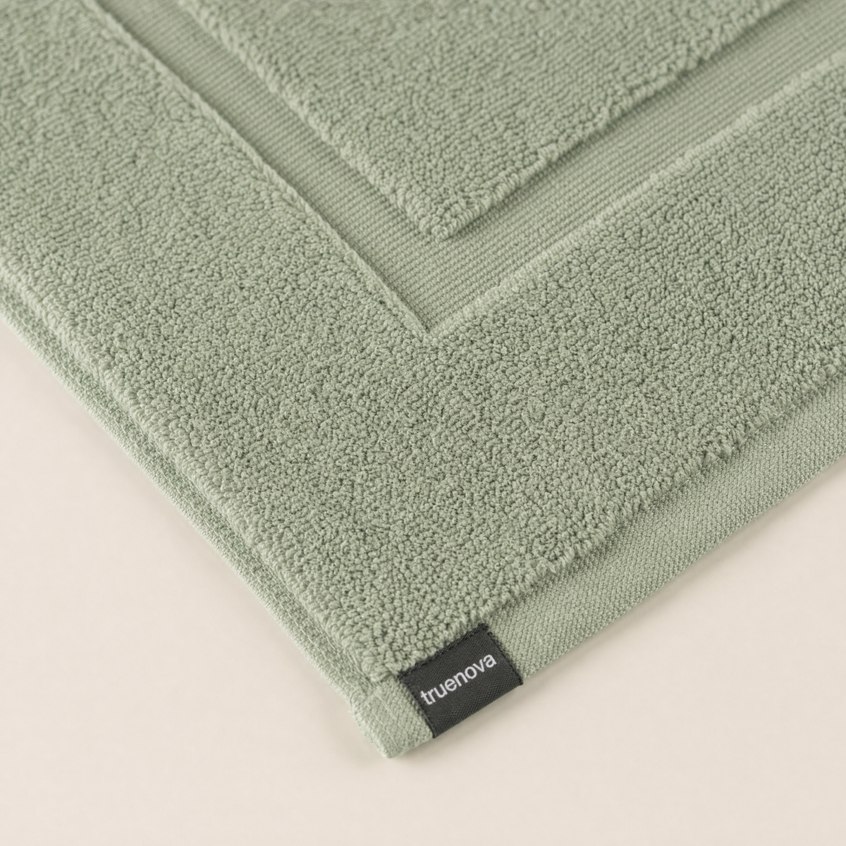Truenova woven label on the corner of a Solace bath mat