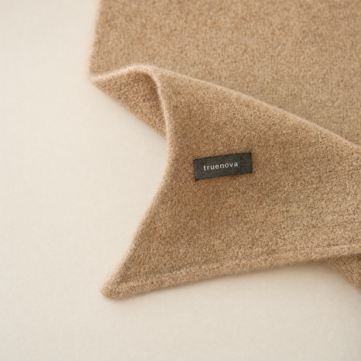 Truenova woven label on the tip of the Muse shawl