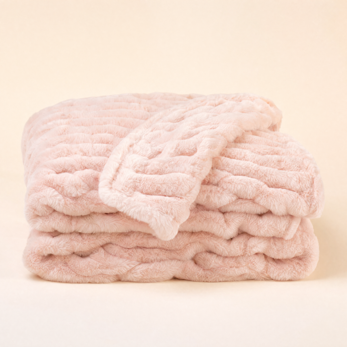 Embrace plush hug blanket in blush pink, folded
