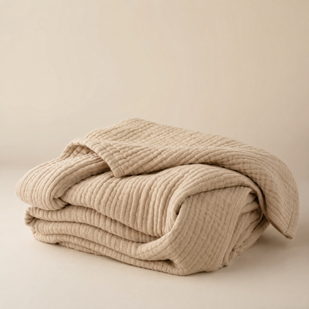 Muslin cotton blanket in dune, folded