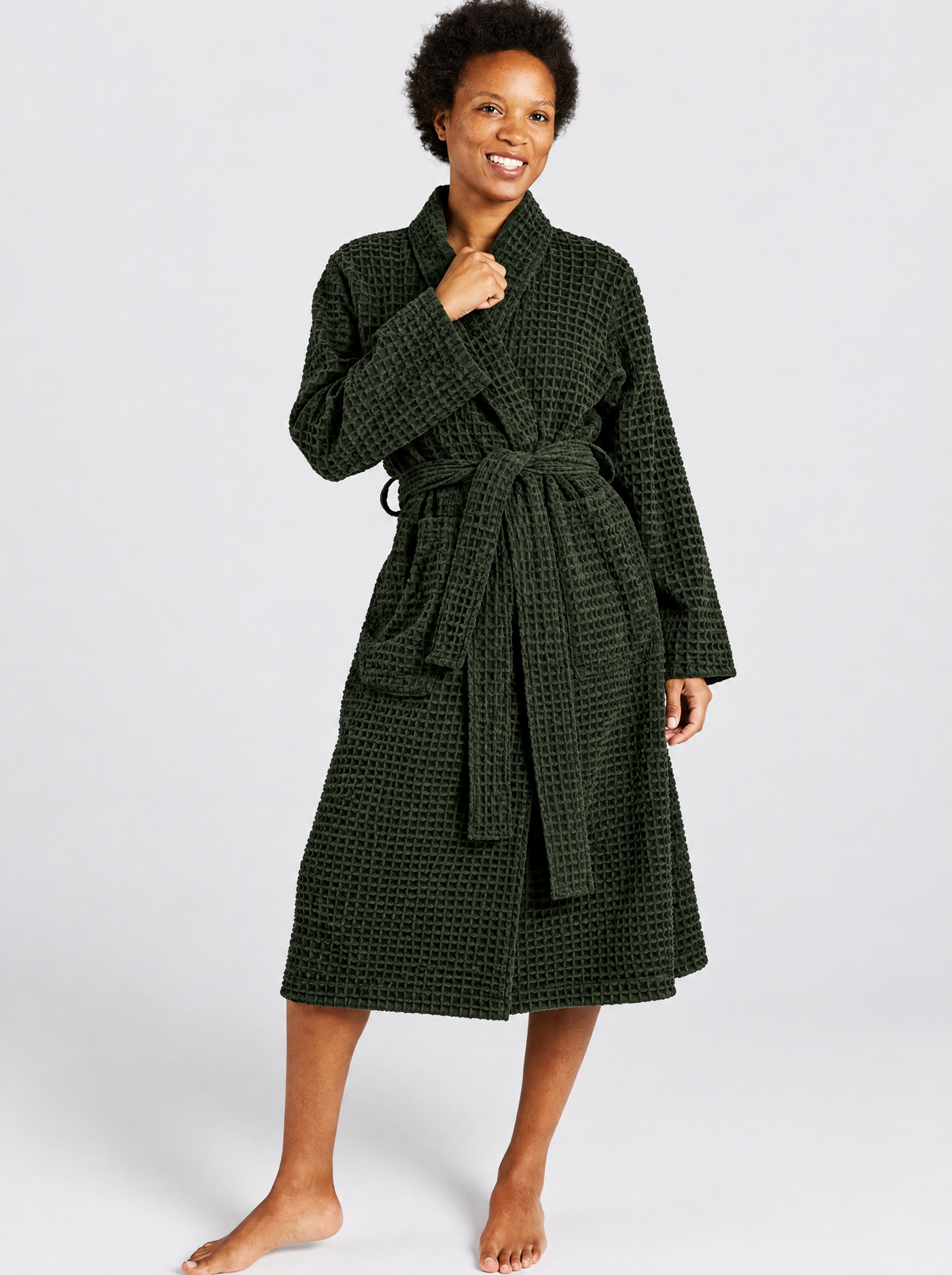 Woman wearing the Truenova Waffle Robe in Evergreen