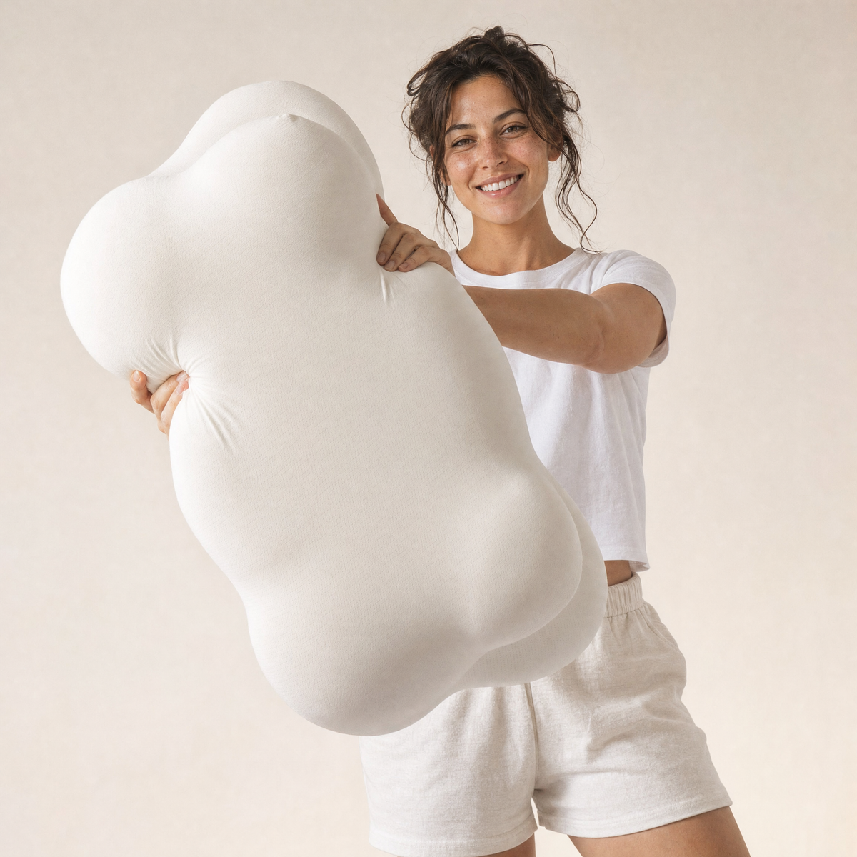 Woman holding the Orbit contour pillow