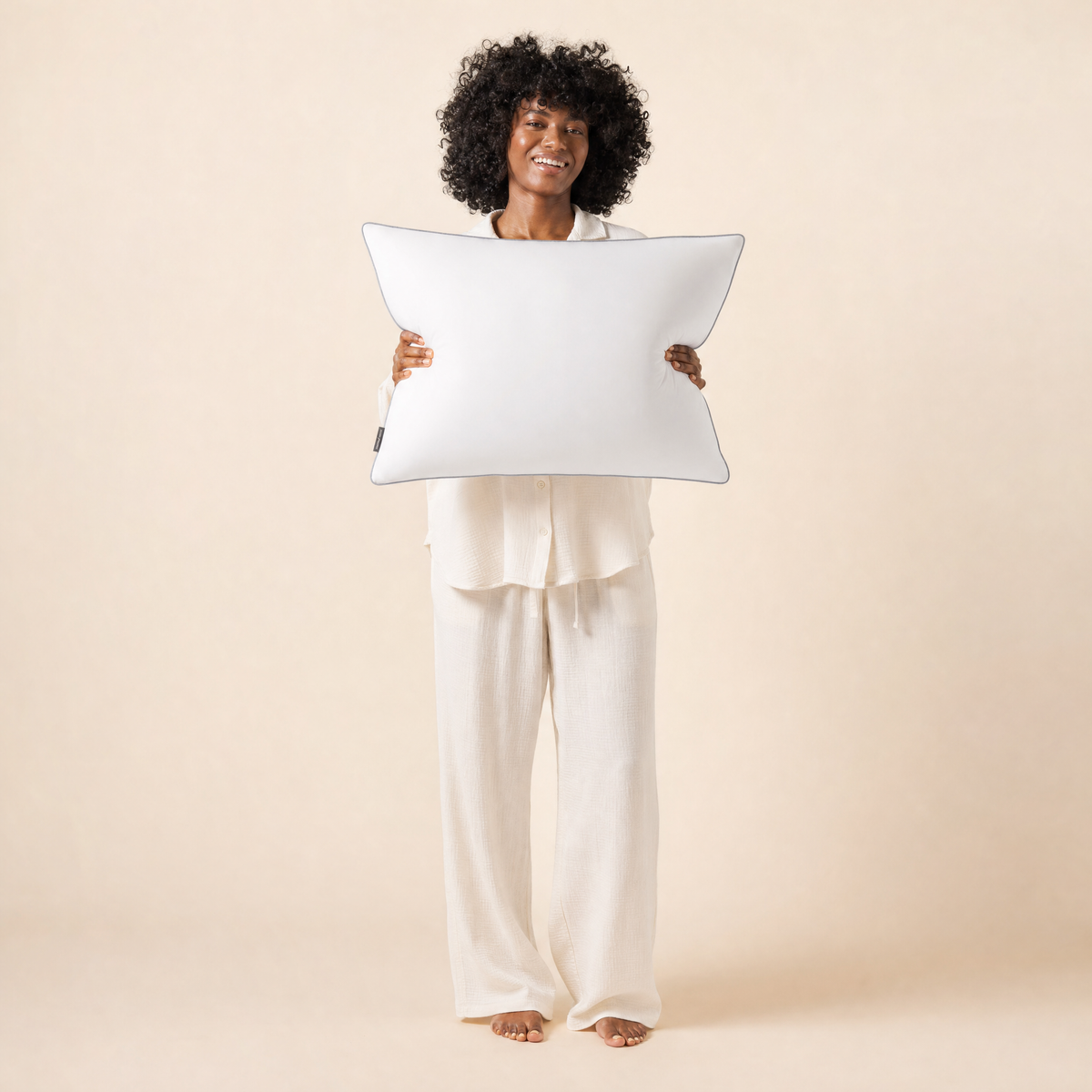 Woman holding the plush Haven hotel pillow
