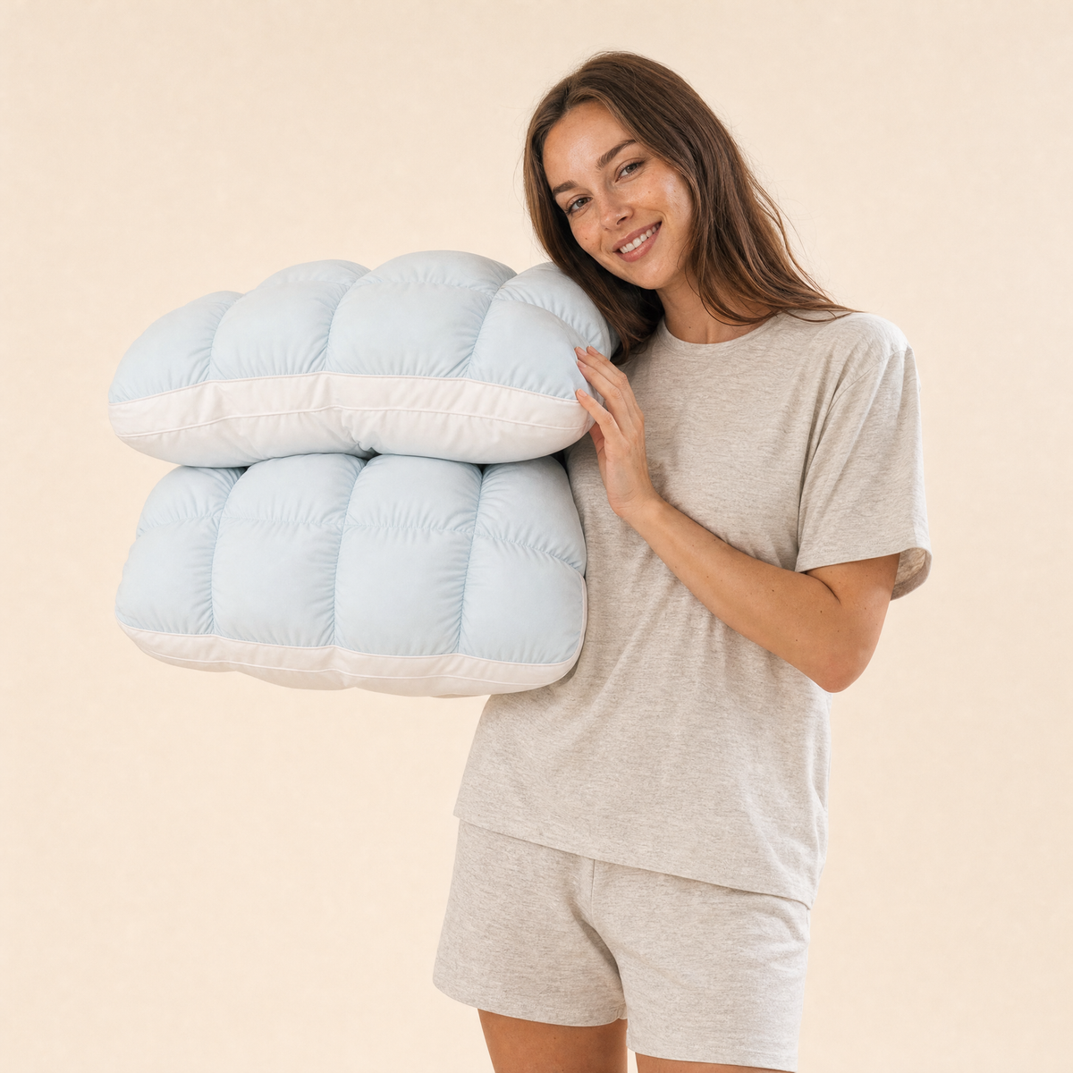 Woman holding two Baby Blue Lune pillows