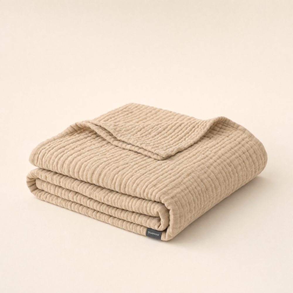 Breeze breathable muslin blanket by Truenova in Dune, folded
