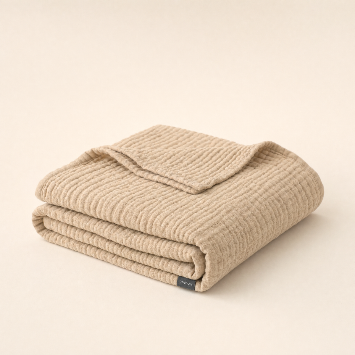 Breeze breathable muslin blanket by Truenova in Dune, folded