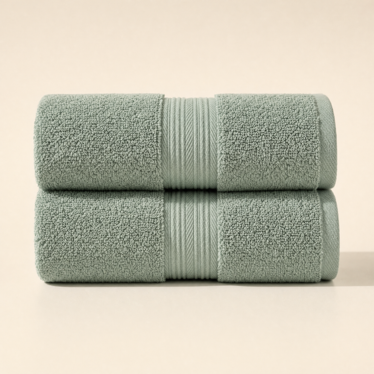 Two folded Solace bath towels in Sage