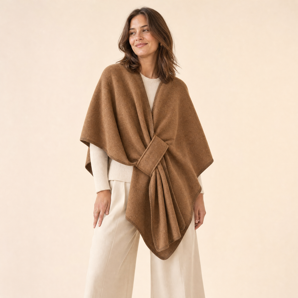 Woman wearing the Truenova Aura fleece drape wrap in Camel