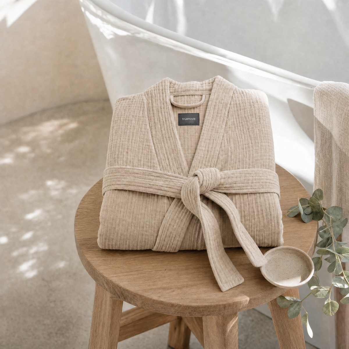 Folded Breeze muslin robe on a bathroom stool