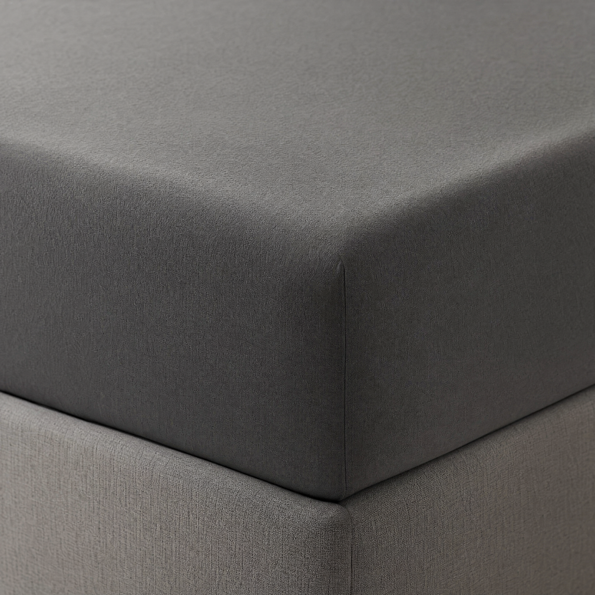 Deep pocket fitted sheet hugging a tall mattress corner